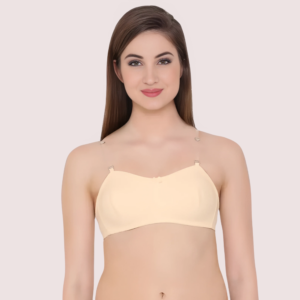 Woman wearing a light yellow strapless top against a plain background