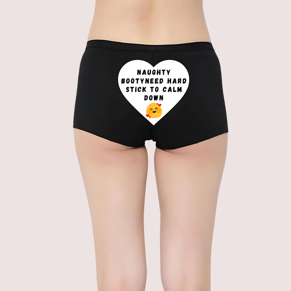 Black shorts with a heart-shaped graphic and text on a plain background