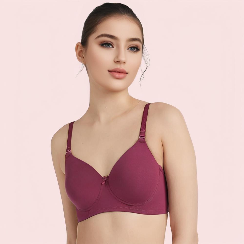 Woman wearing a maroon bra against a pink background