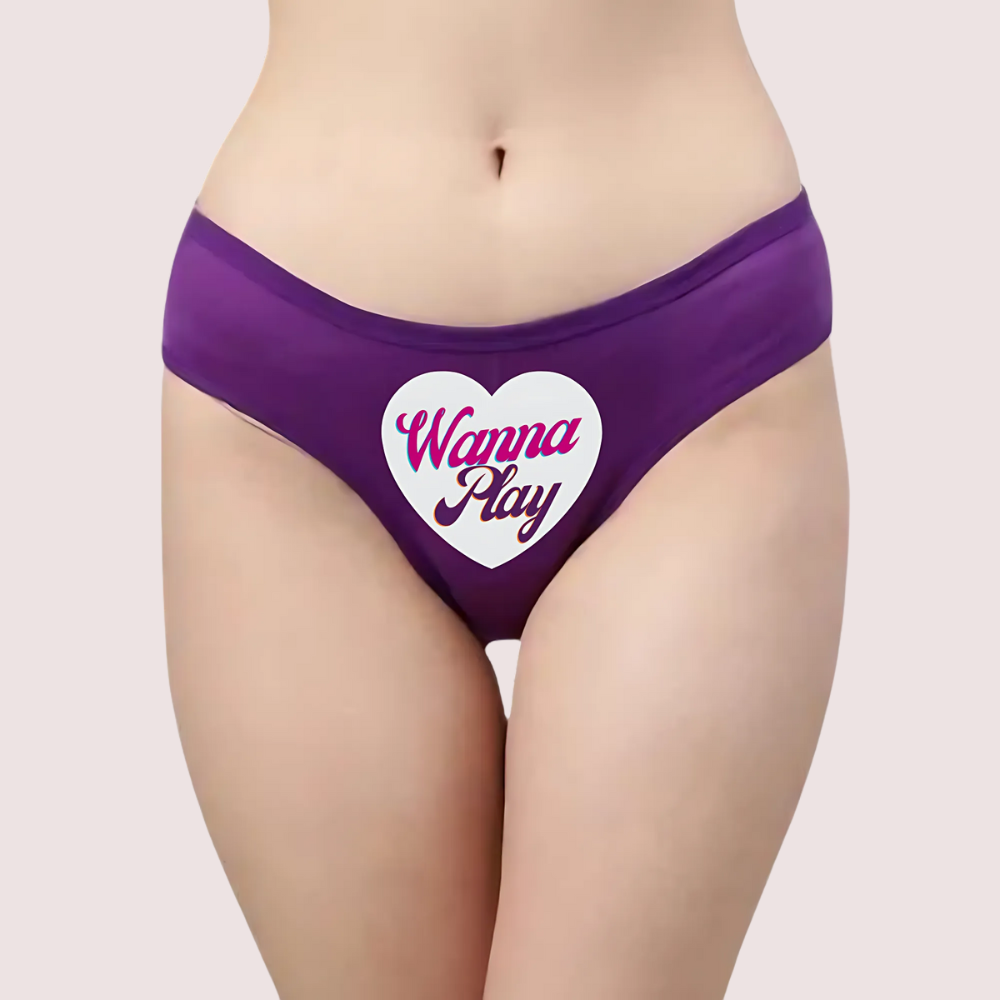 Purple underwear with 'Wanna Play' heart design on a plain background