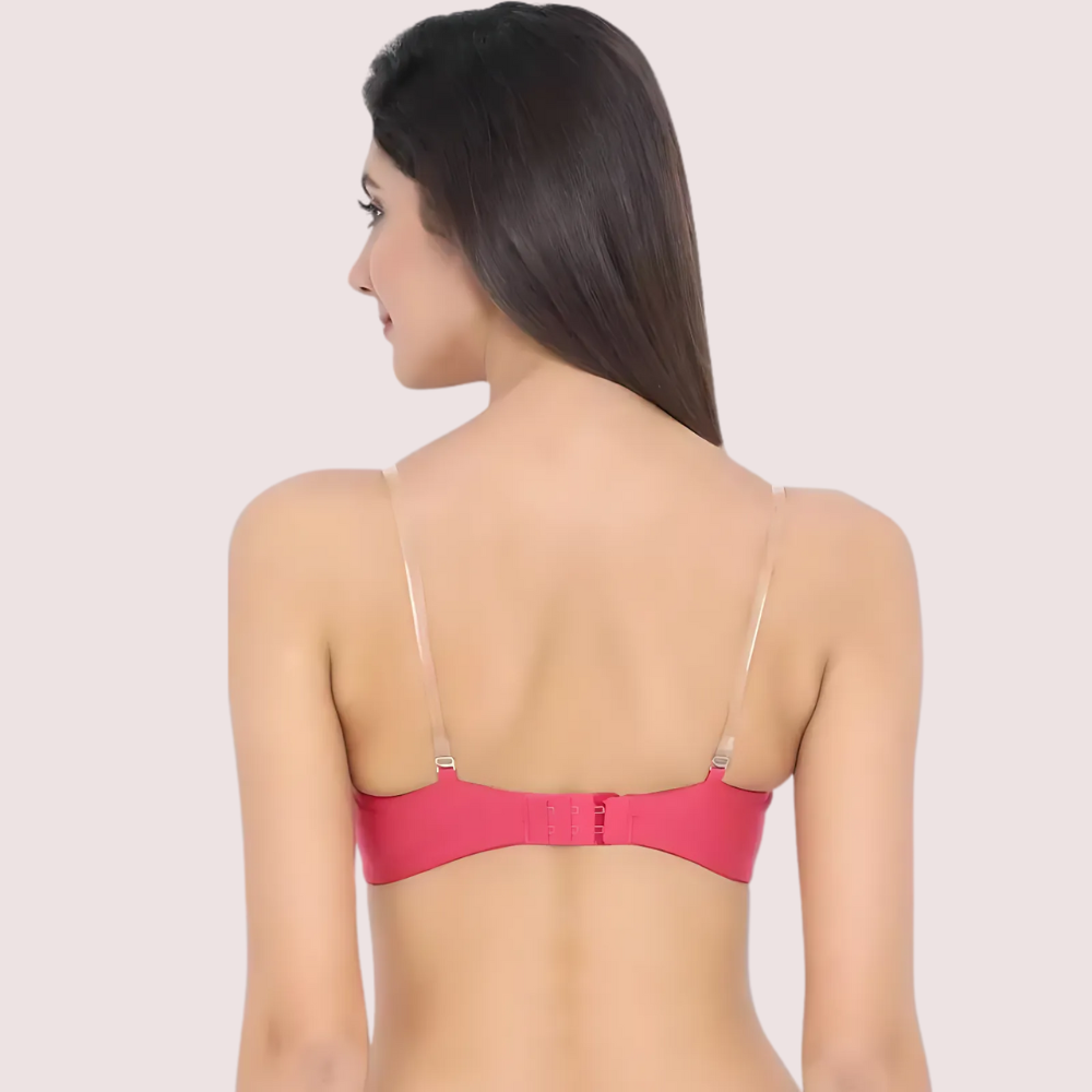 Woman wearing a pink bra against a plain background