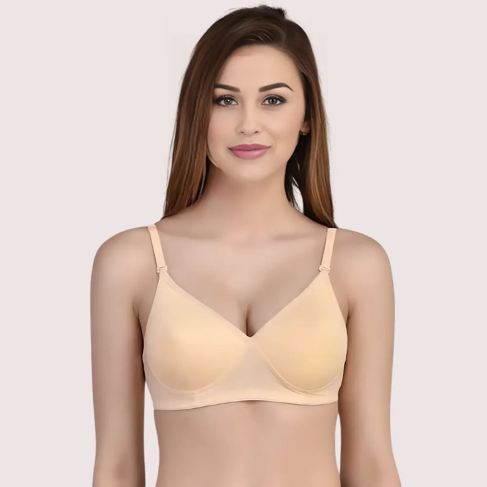 Woman wearing a beige bra against a light pink background