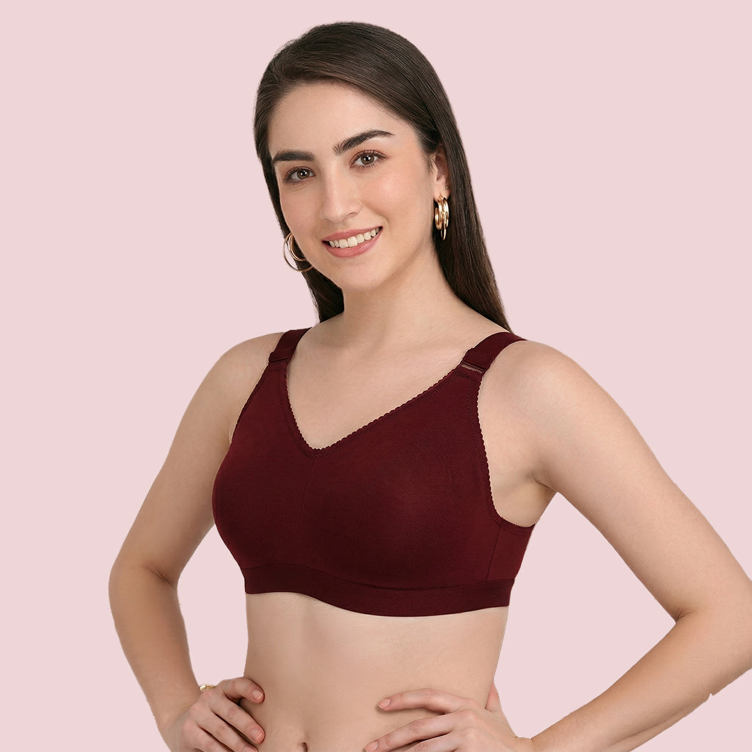Woman wearing a maroon bralette 