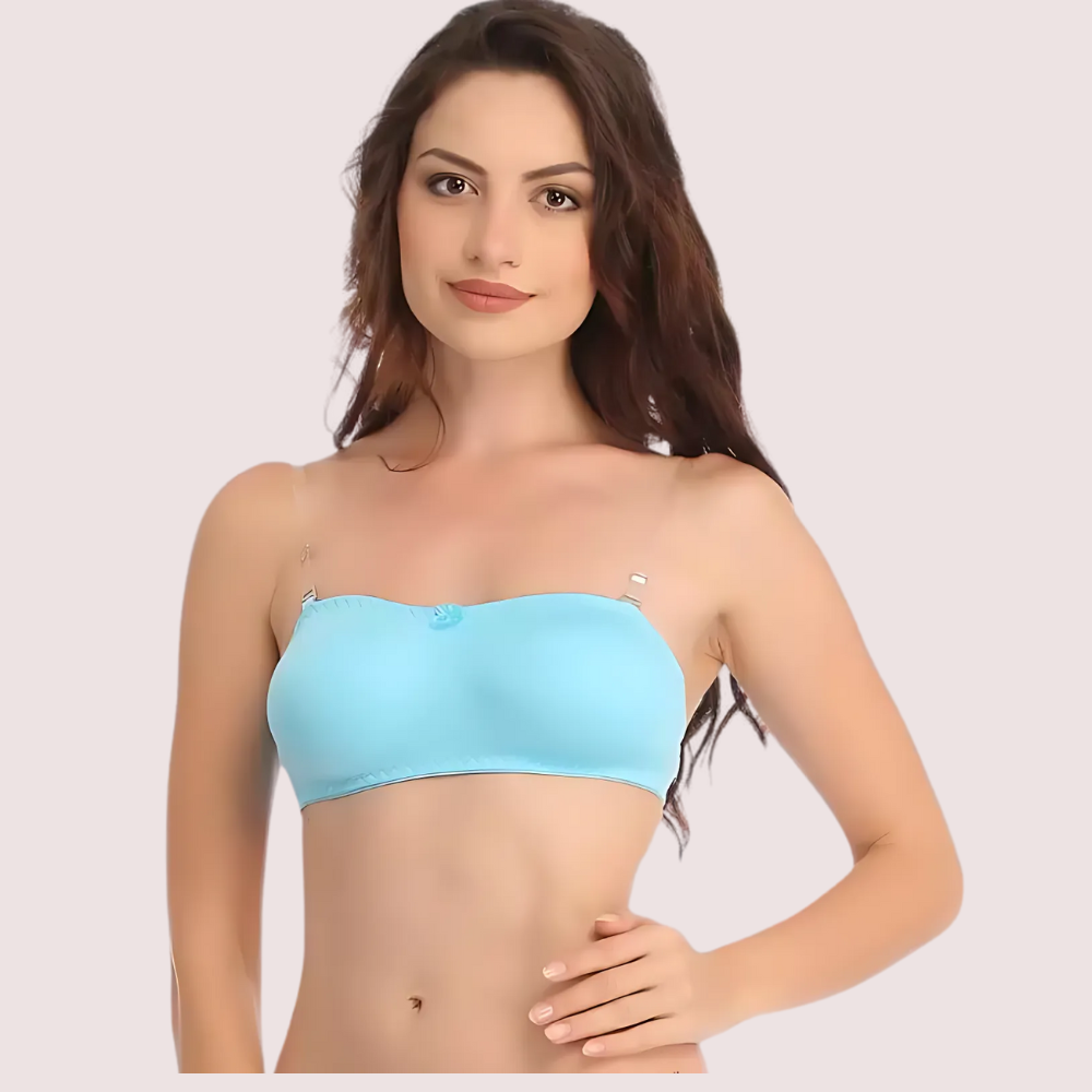 Woman wearing a light blue strapless top against a plain background