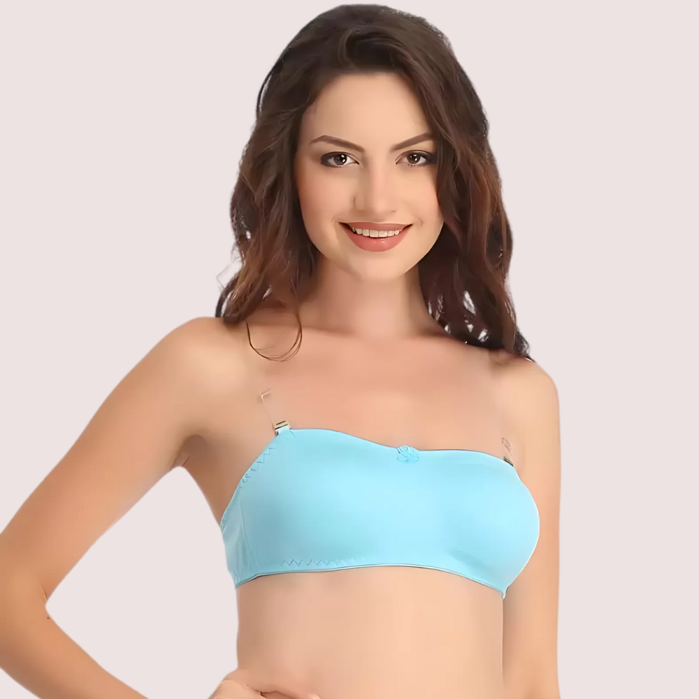 Woman wearing a light blue strapless top against a plain background