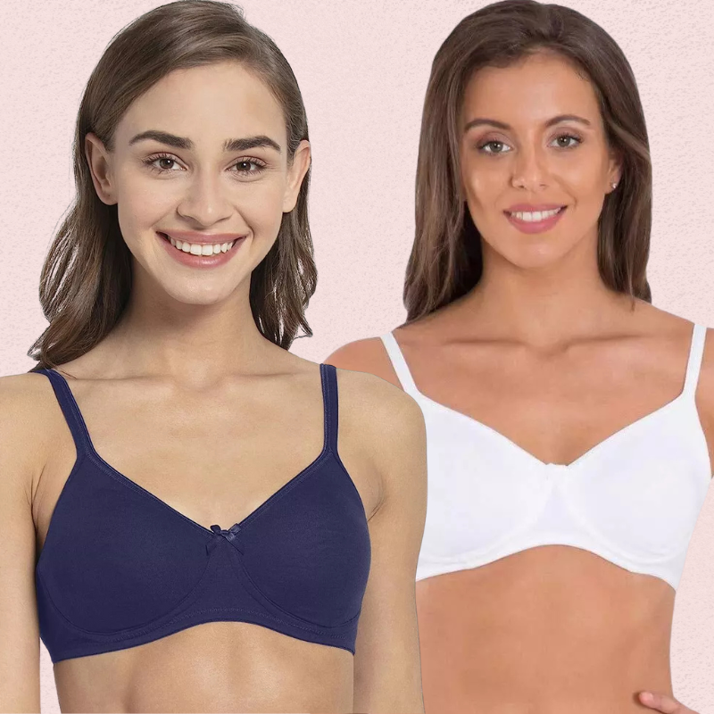 Two women wearing blue and white bras against a pink background