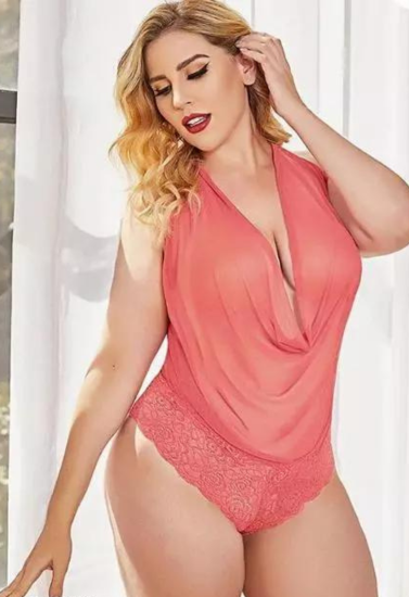 Woman wearing a coral pink lingerie set against a white background