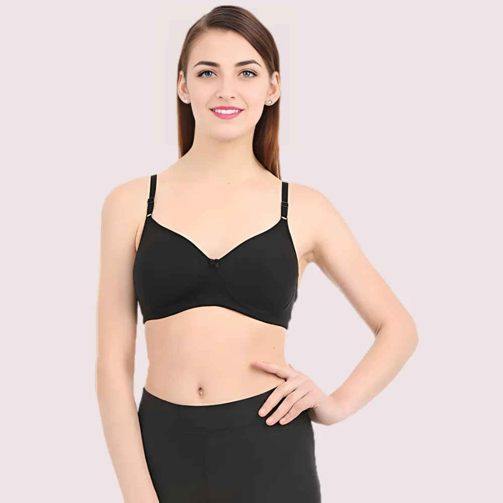 Woman wearing a black bra against a plain background