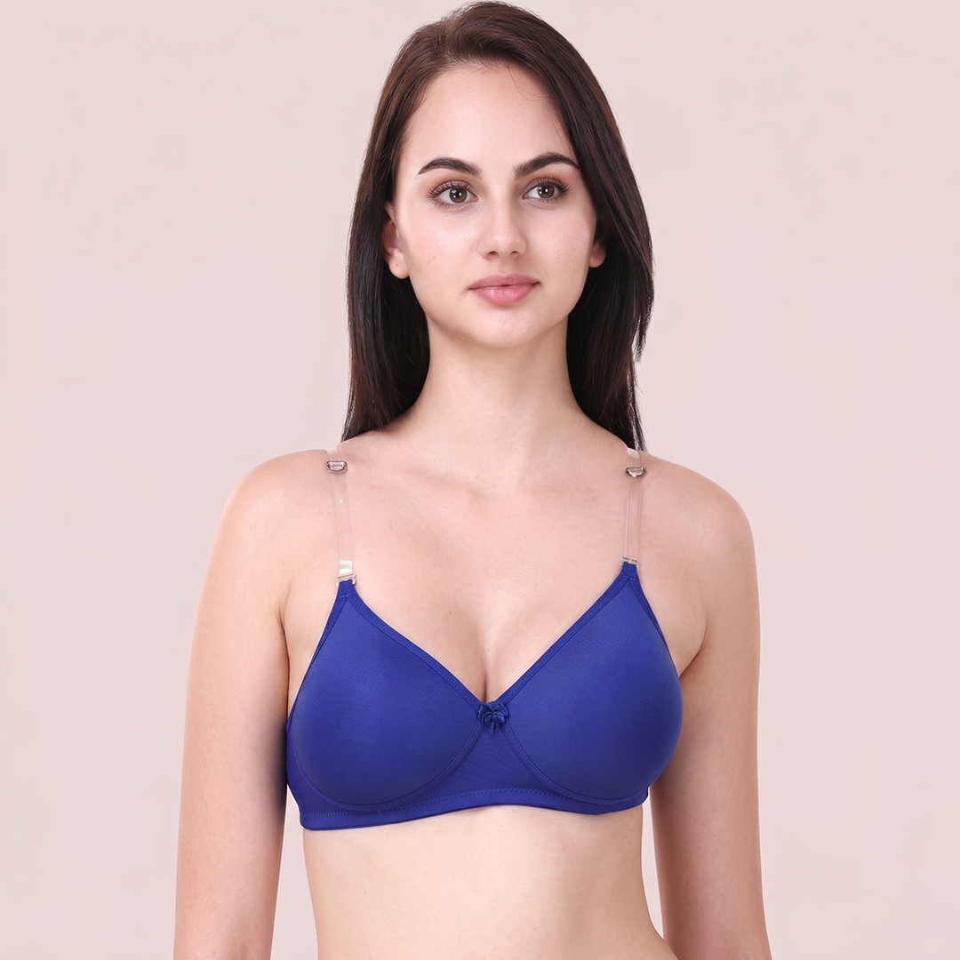 Woman wearing a blue bra against a beige background