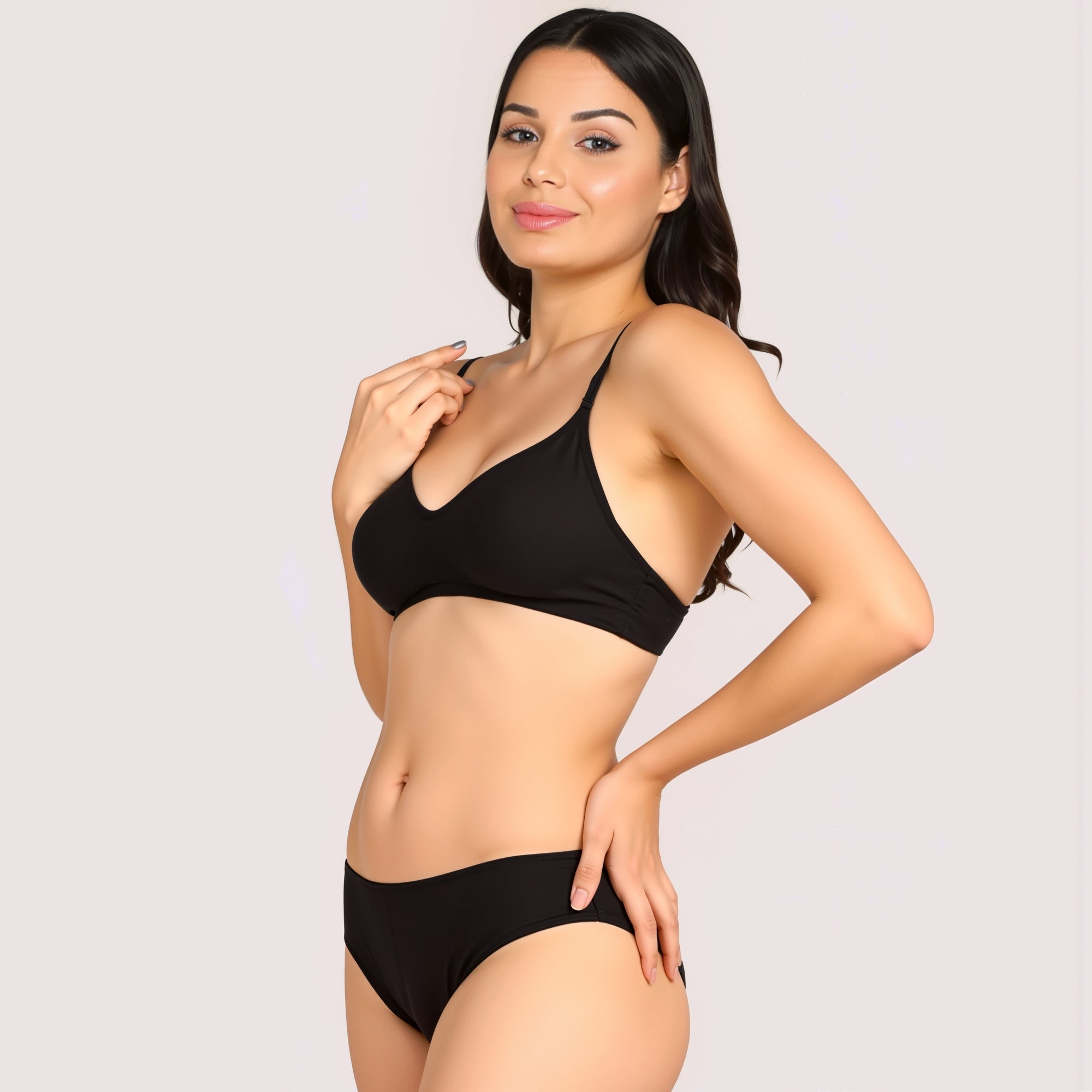 Woman wearing a black bikini set on a plain background