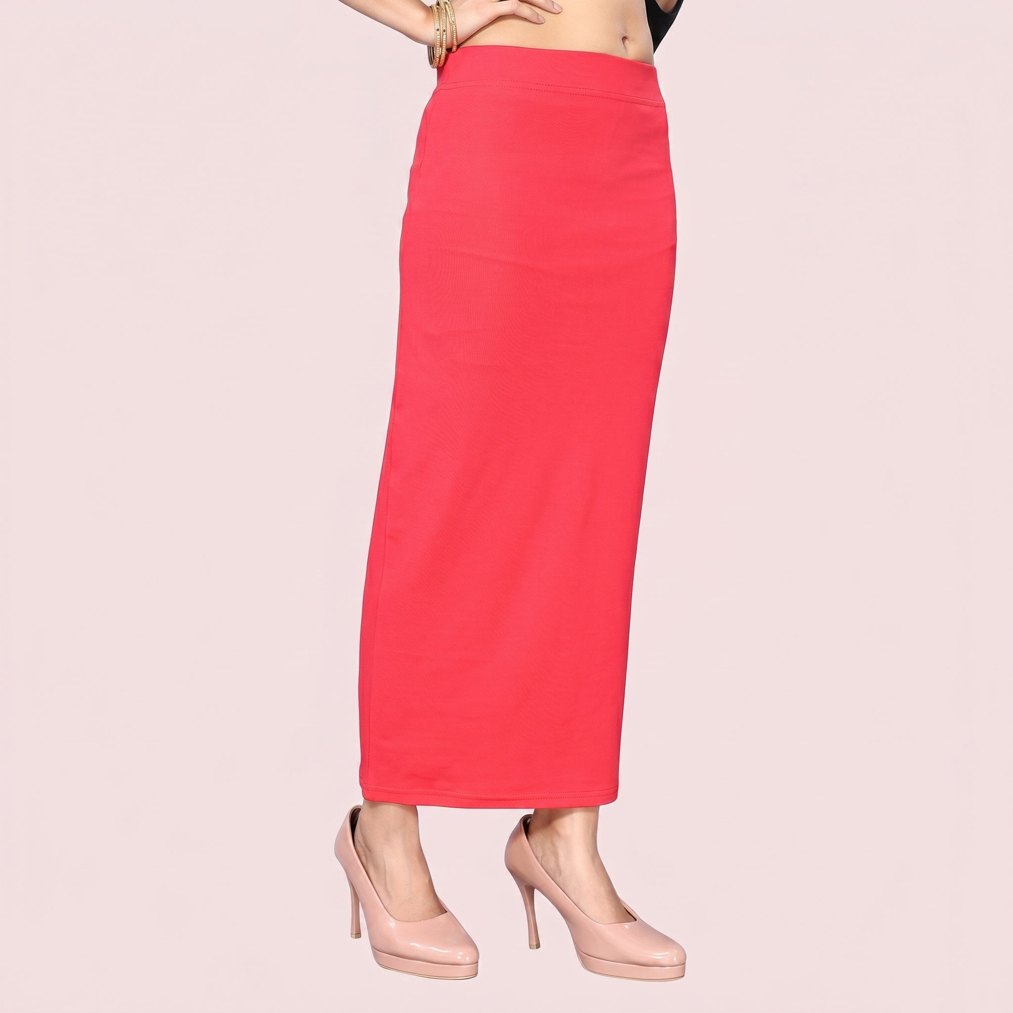 Red skirt worn by a person on a light pink background