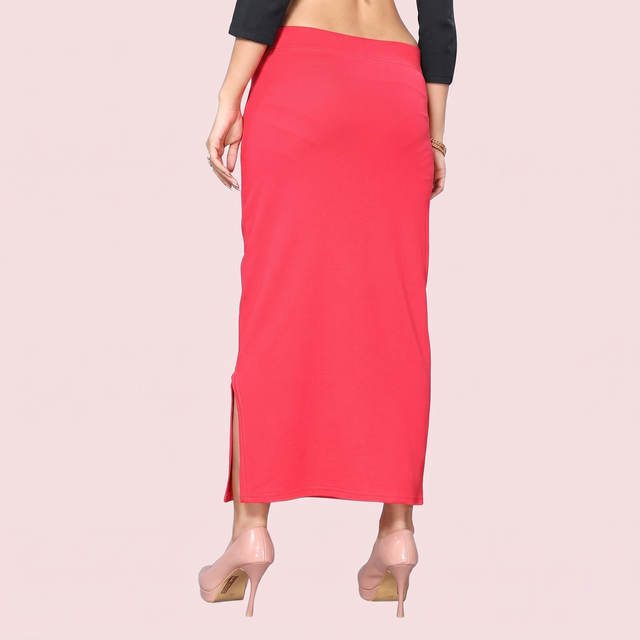 Person wearing a red skirt with a plain background