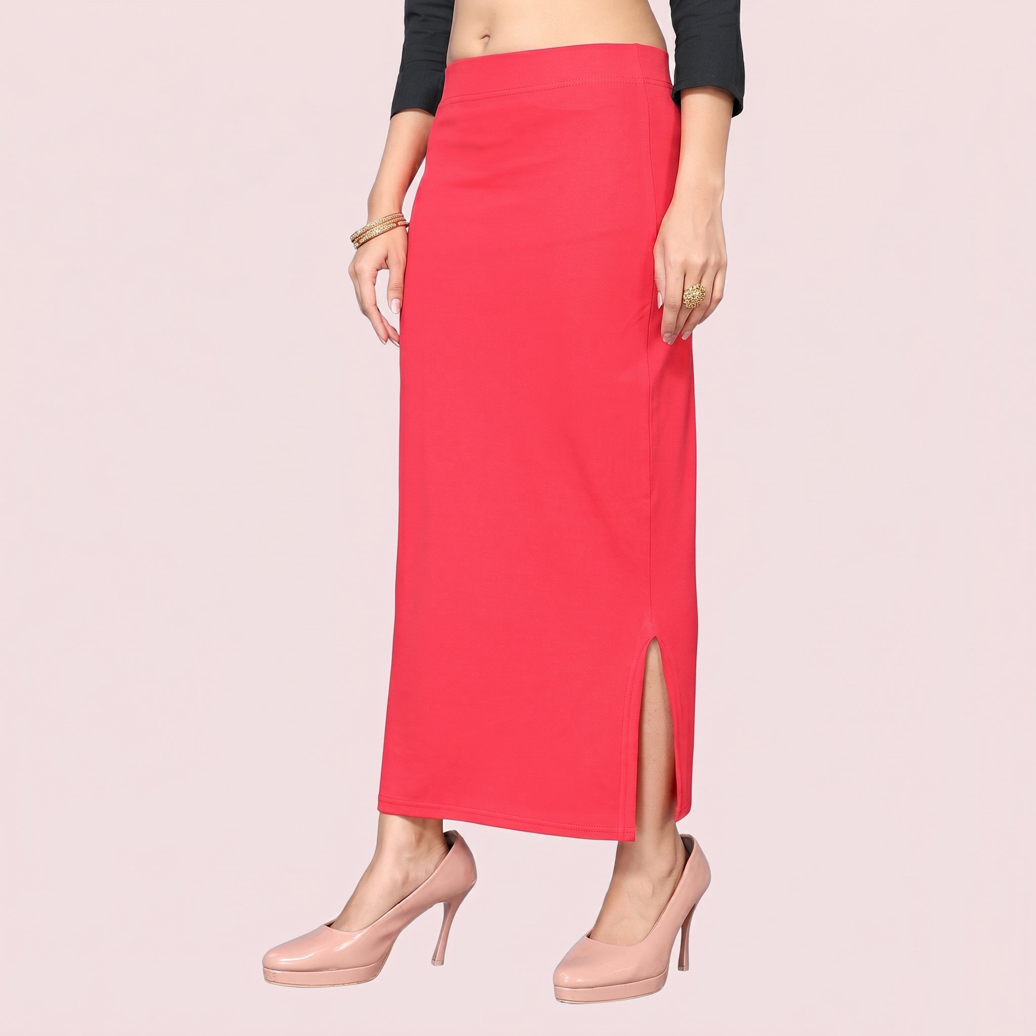 Red skirt with a slit worn by a person on a light pink background