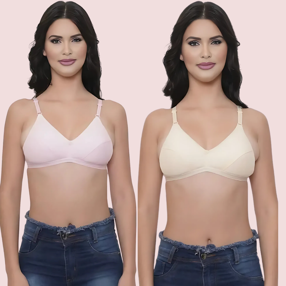 Two women wearing different colored bras against a pink background