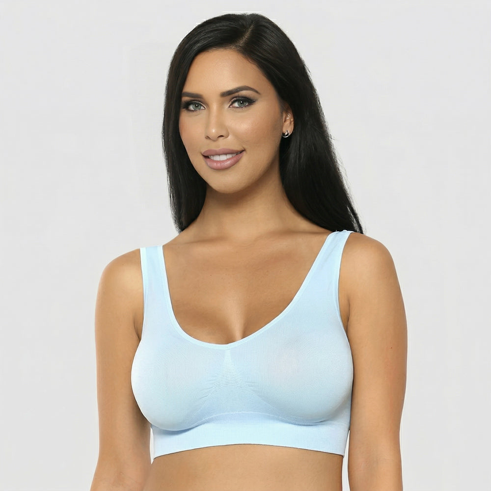 Woman wearing a light blue bralette against a plain background