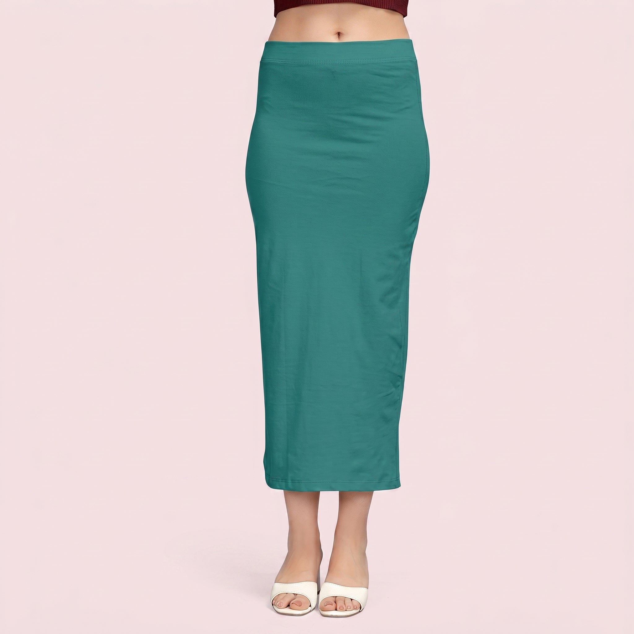 Teal pencil skirt worn by a person on a pink background