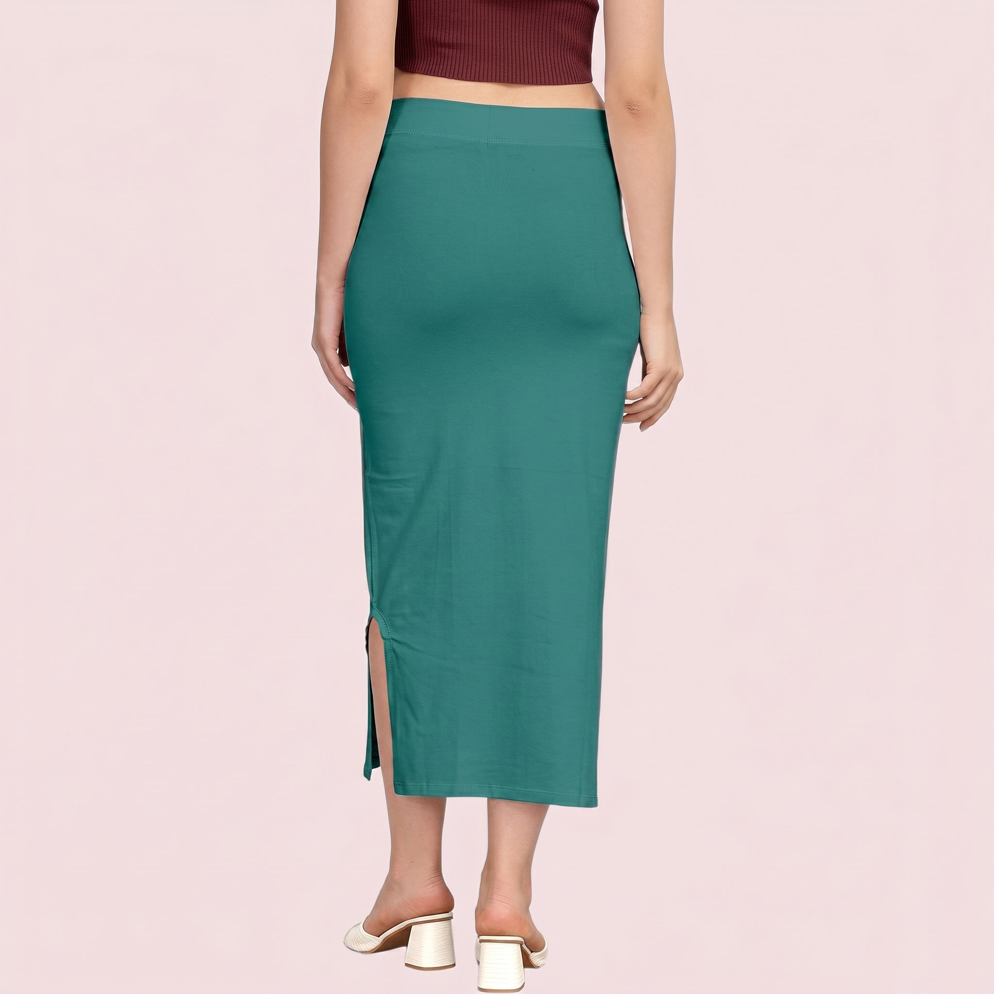 Teal pencil skirt worn by a person on a pink background