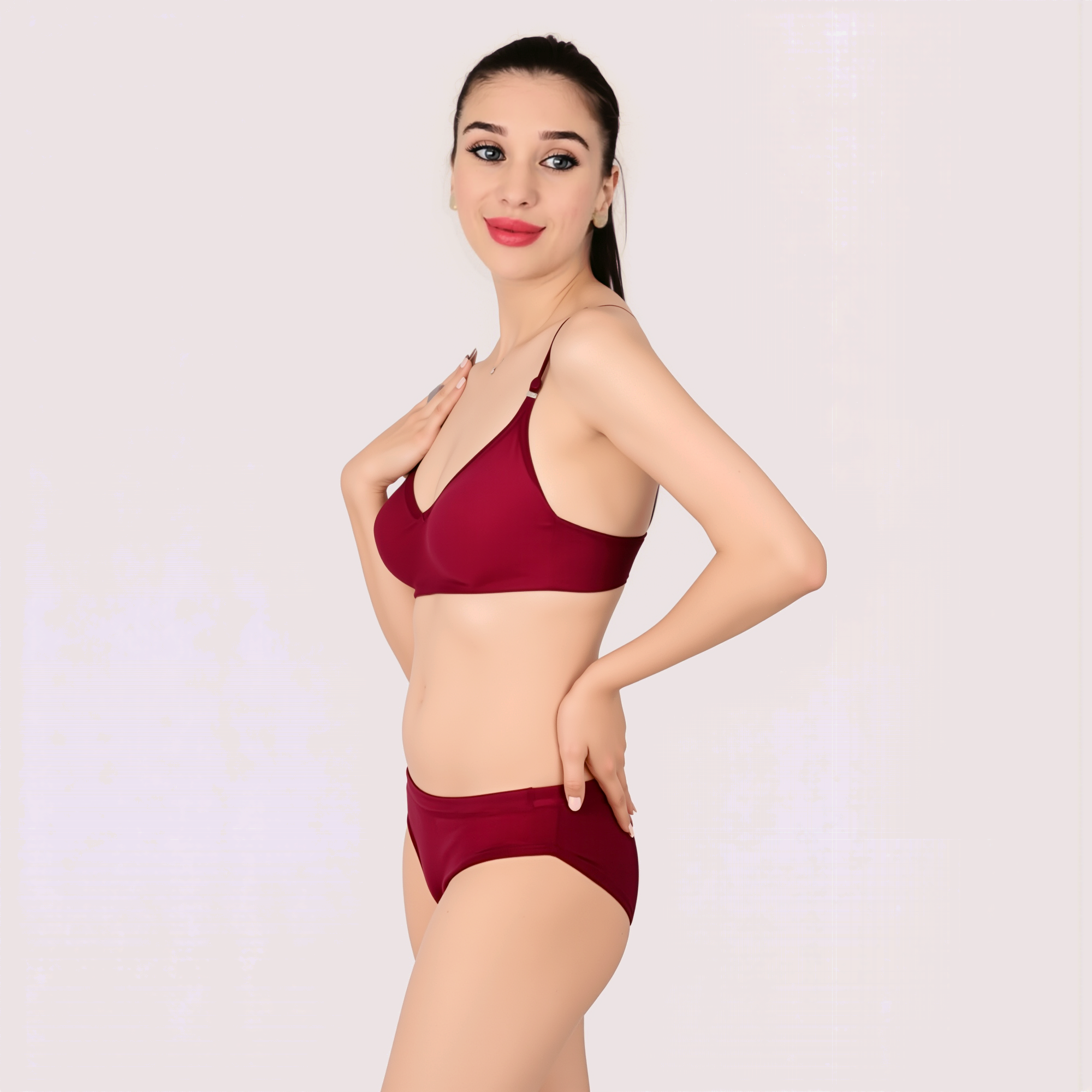 Woman wearing a red bikini set on a light pink background