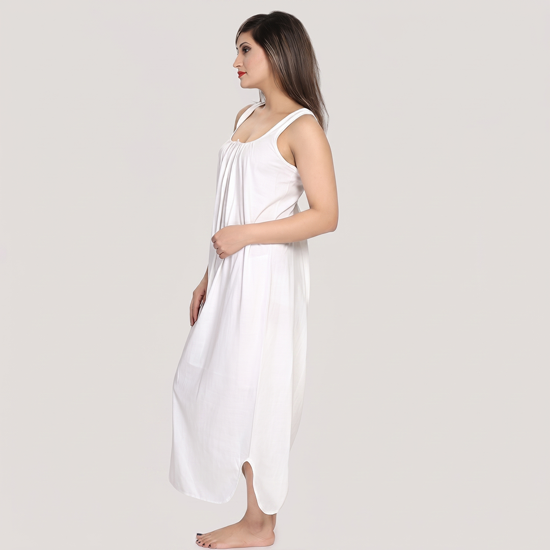 Woman wearing a white dress against a plain background
