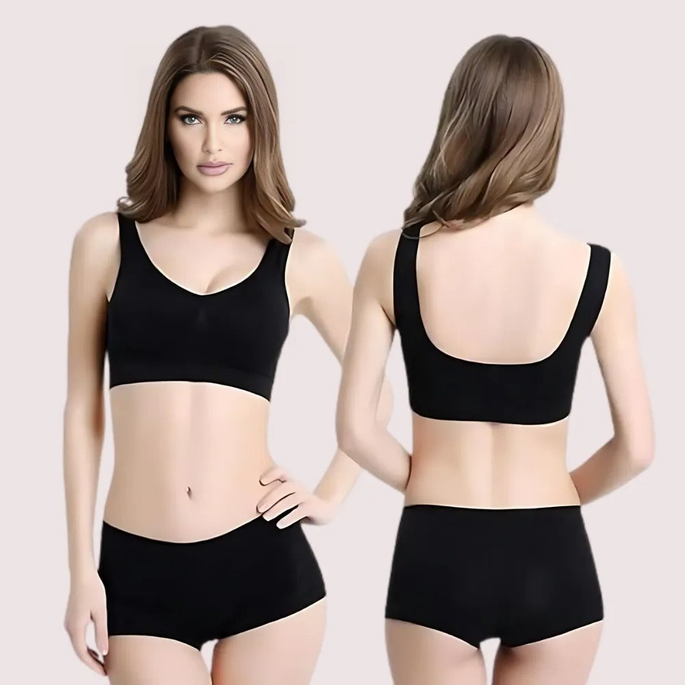Black sports bra and shorts set on a model against a plain background