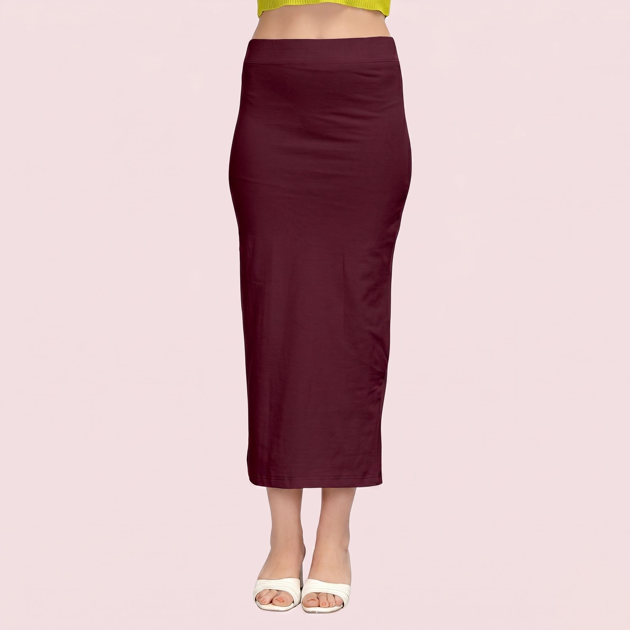 Maroon pencil skirt worn by a person on a light pink background