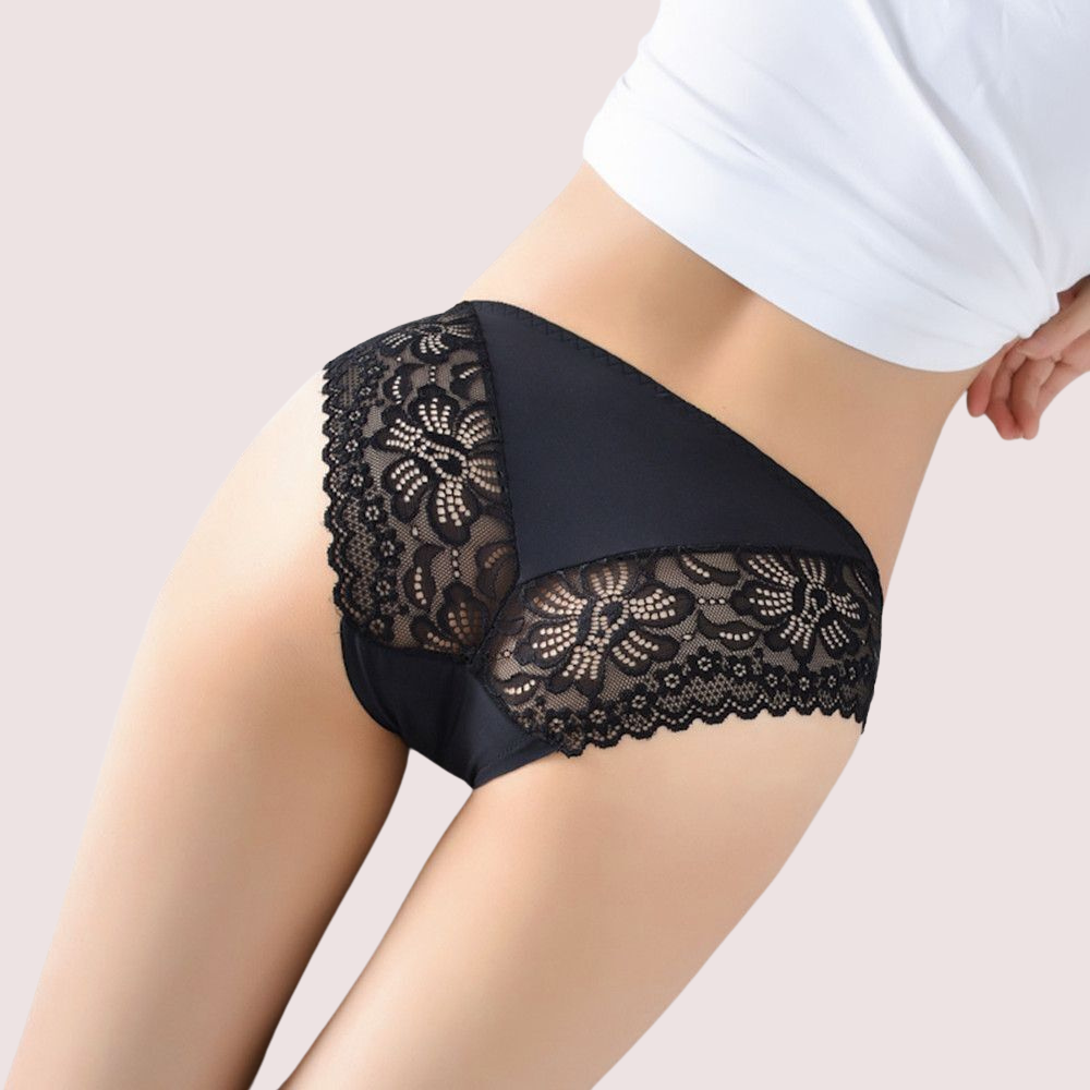 Black lace underwear worn by a person on a light background