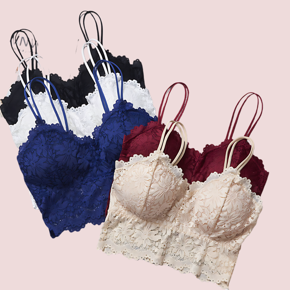 Set of lace bras in black, blue, white, and red on a pink background