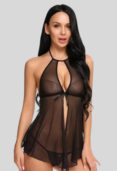 Woman wearing a sheer black dress against a gray background
