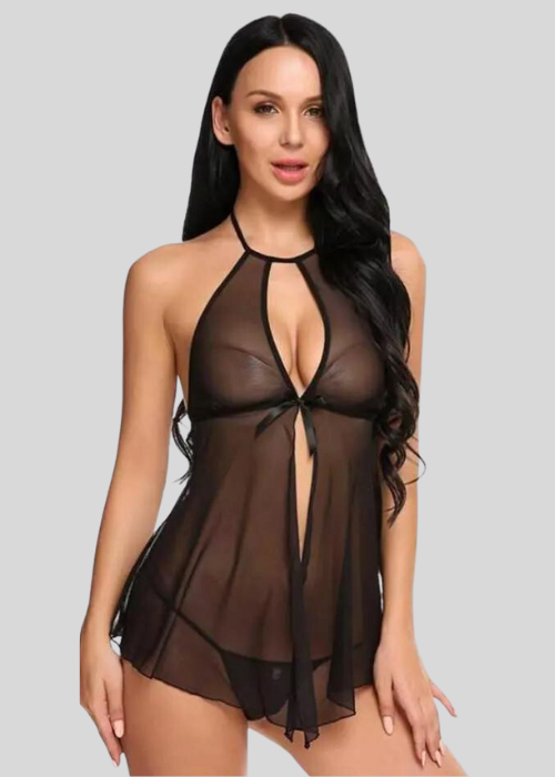 Woman wearing a sheer black dress on a gray background