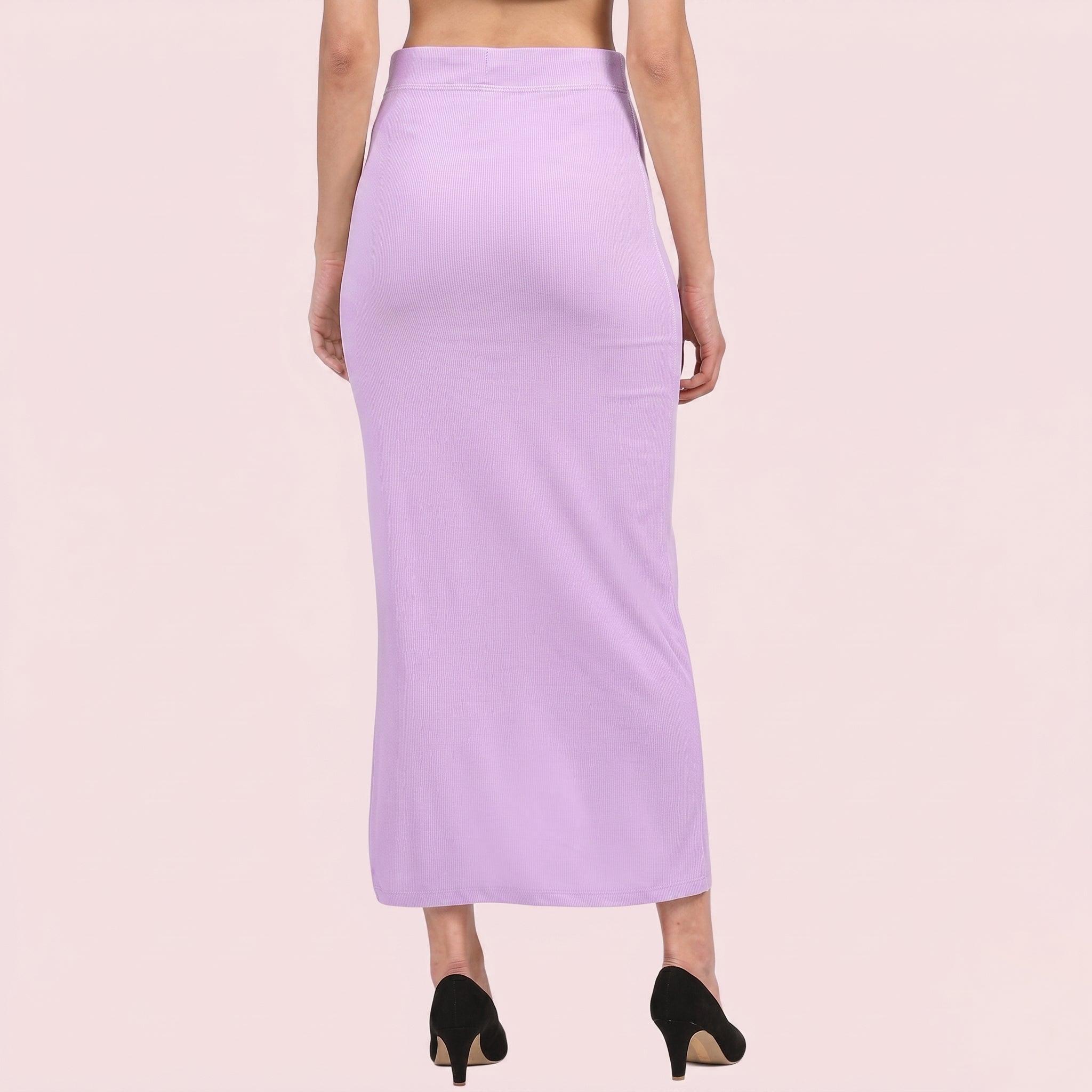 Person wearing a light purple skirt on a plain background