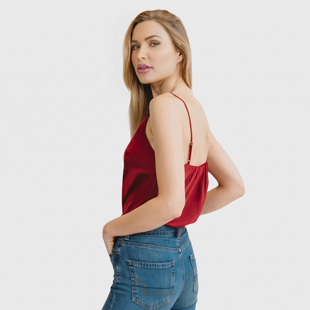 Woman wearing a red top and blue jeans on a white background
