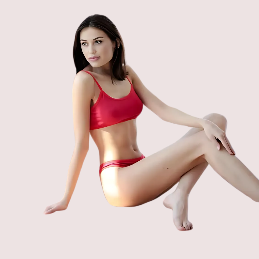 Woman wearing a red bikini sitting on a light pink background