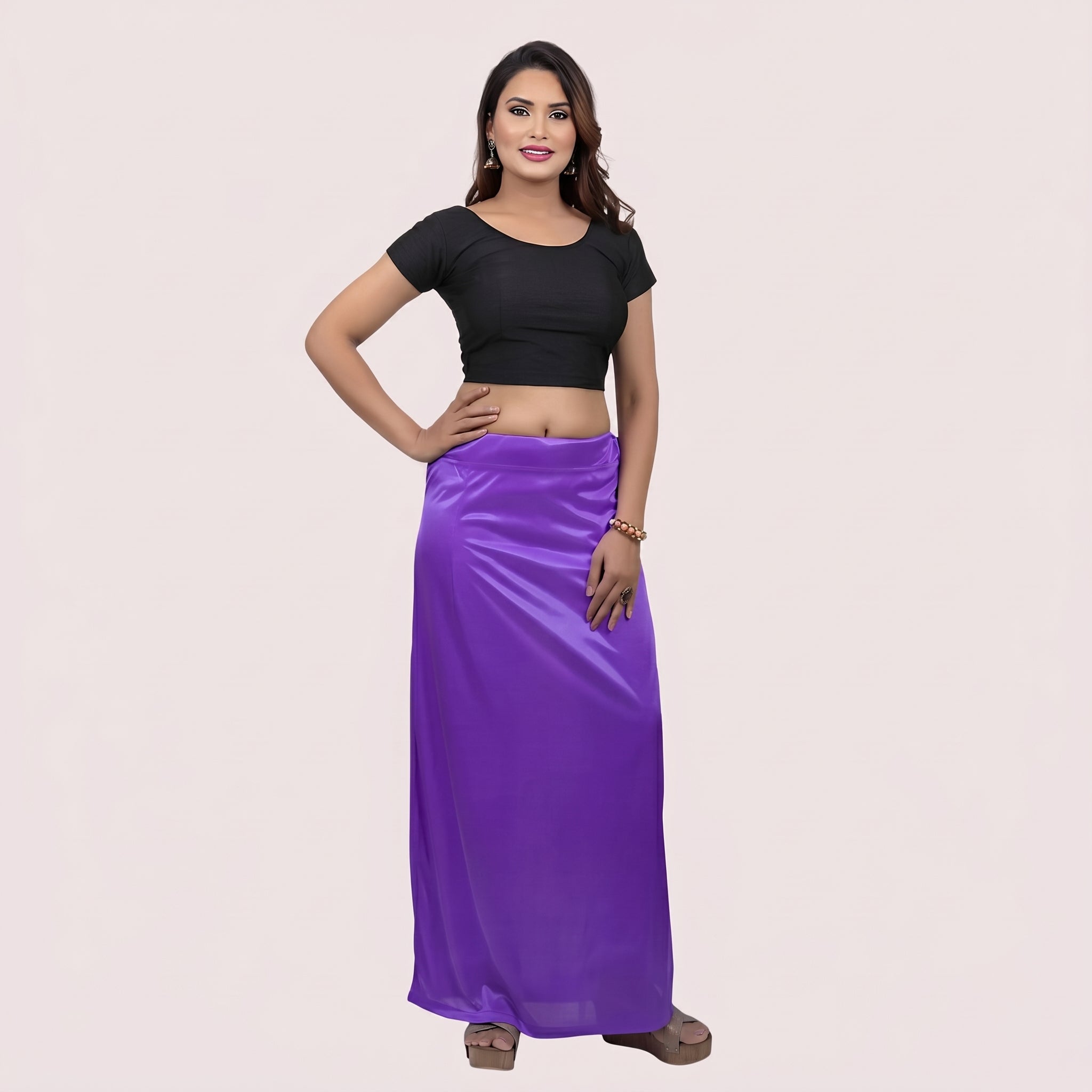 Woman wearing a black top and purple skirt on a beige background