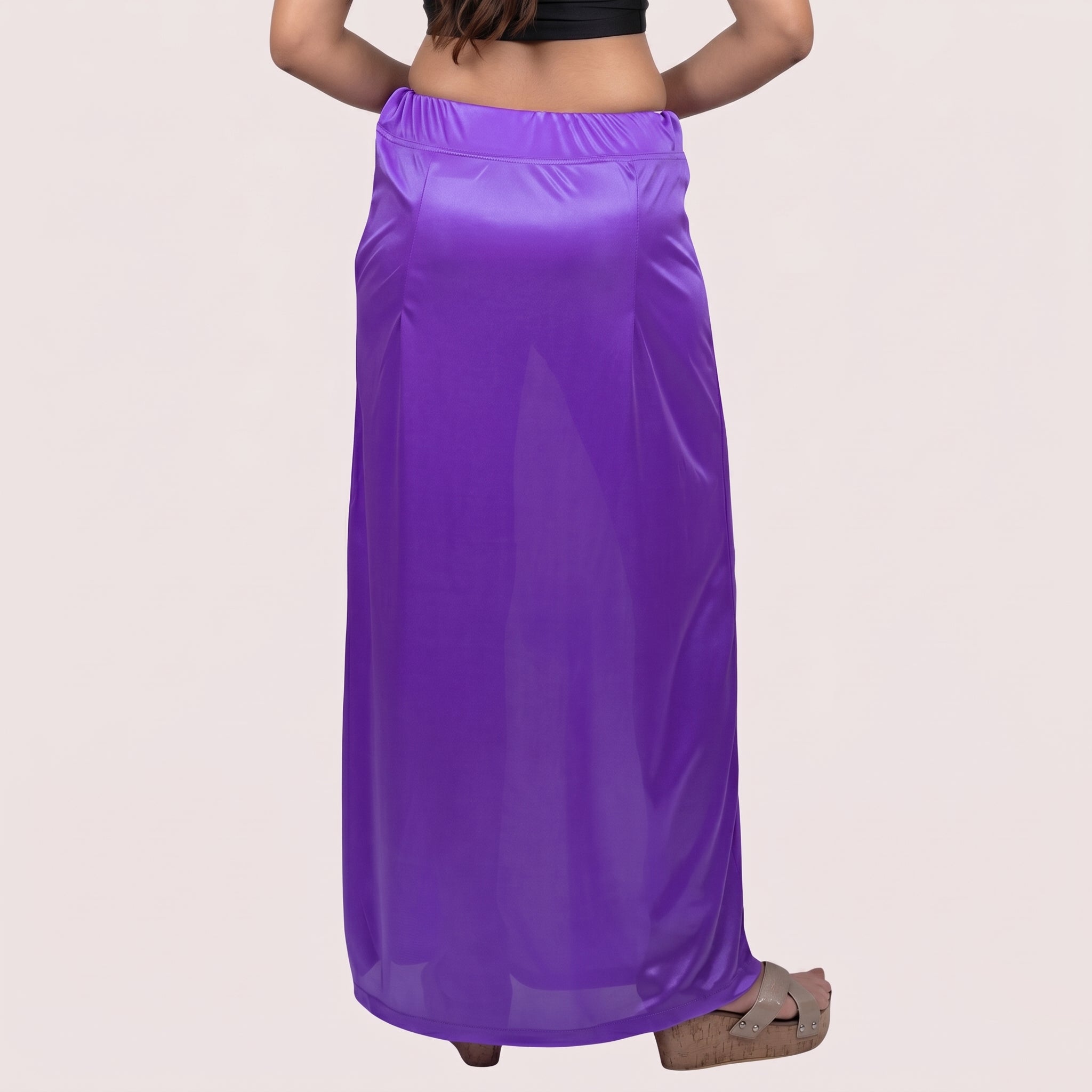 Purple maxi skirt worn by a person on a light pink background