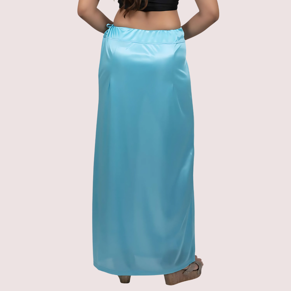 Person wearing a light blue satin skirt on a plain background