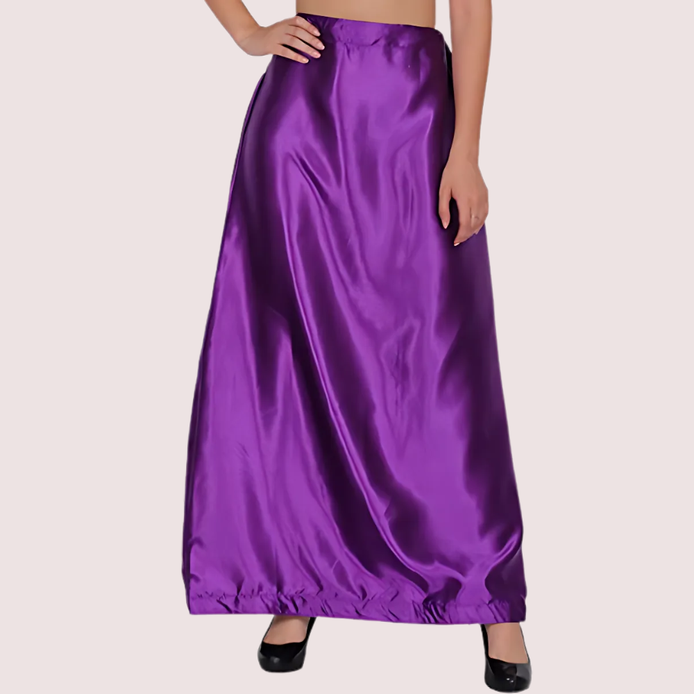 Purple satin skirt worn by a person on a plain background