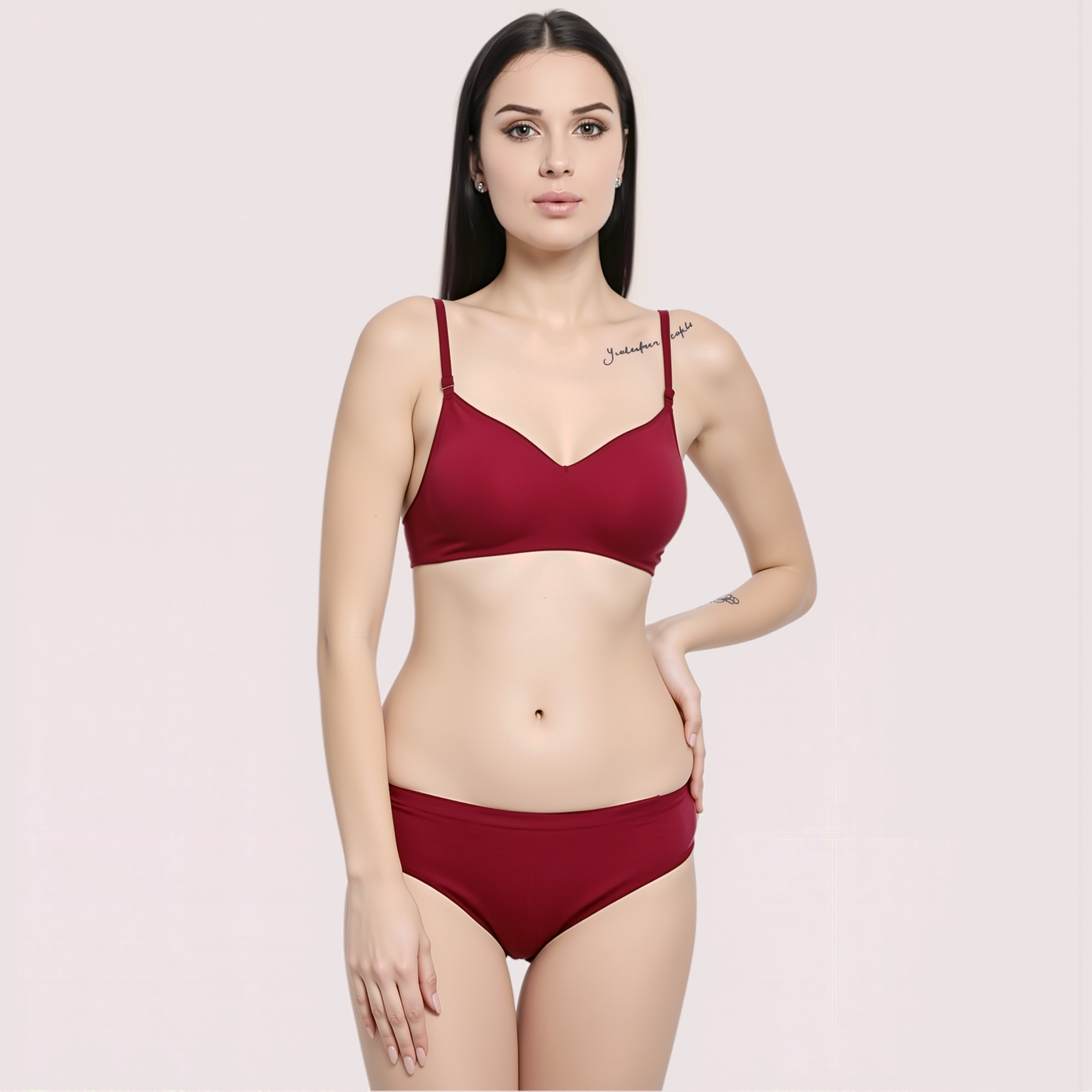 Woman wearing a red bra and panties set on a light pink background