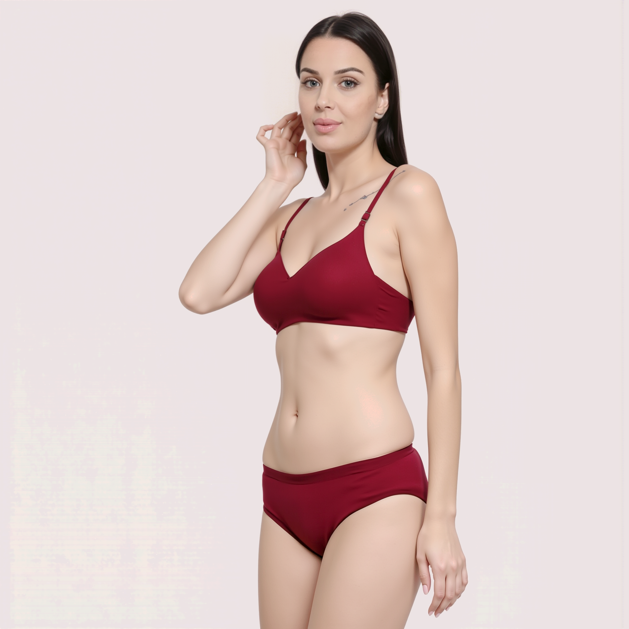 Woman wearing a red bikini set on a light pink background