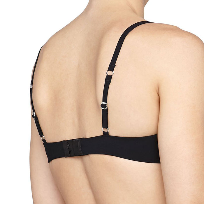 Black bra worn by a person on a white background