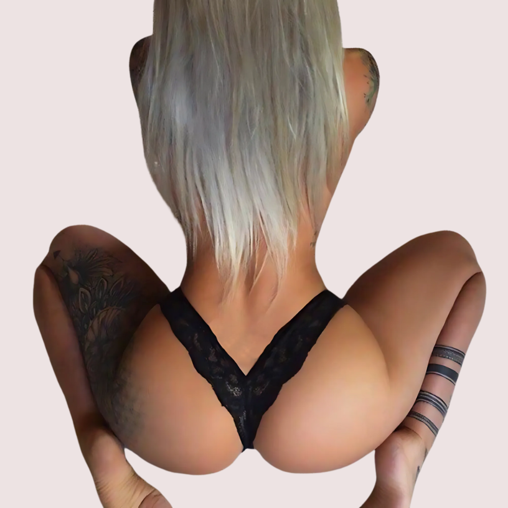 Person wearing a black lace bra with a neutral background