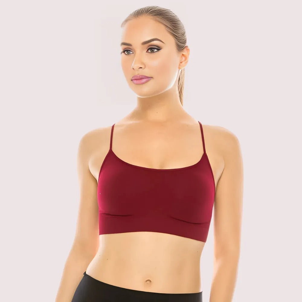 Woman wearing a maroon sports bra on a light gray background