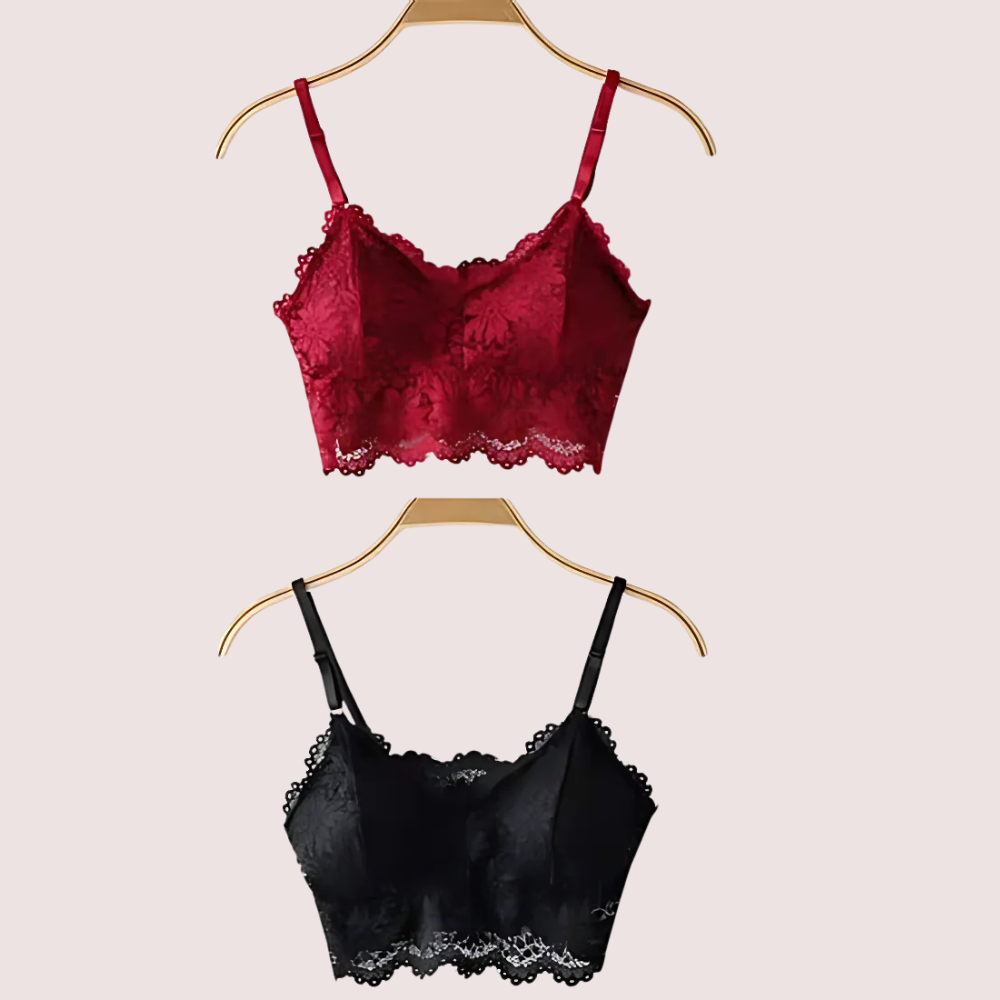 Red and black lace bras on hangers against a beige background