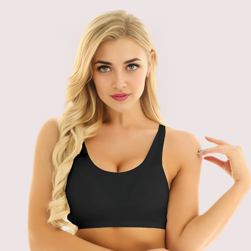 Woman wearing a black sports bra against a light background