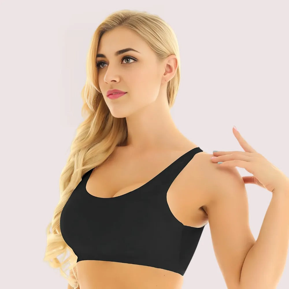 Woman wearing a black sports bra against a plain background