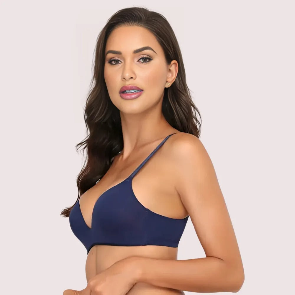 Woman wearing a navy blue bra against a light background