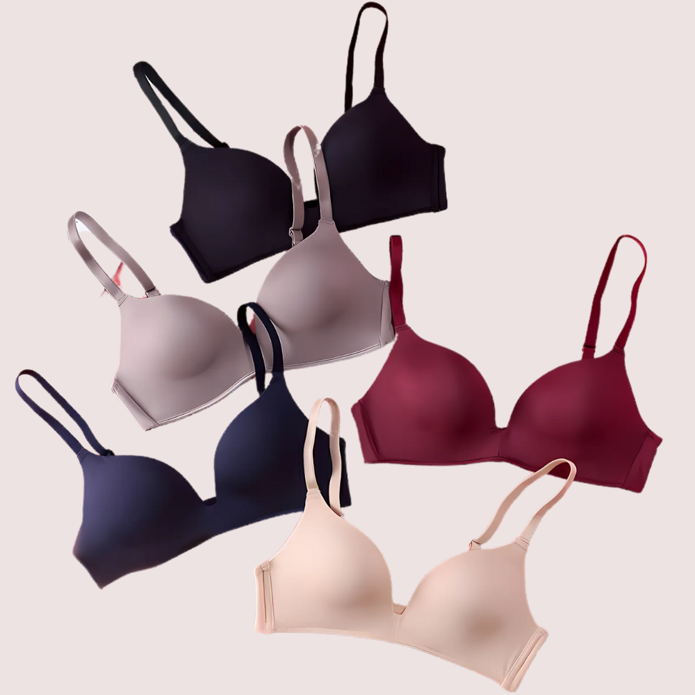 Set of six bras in various colors on a light pink background