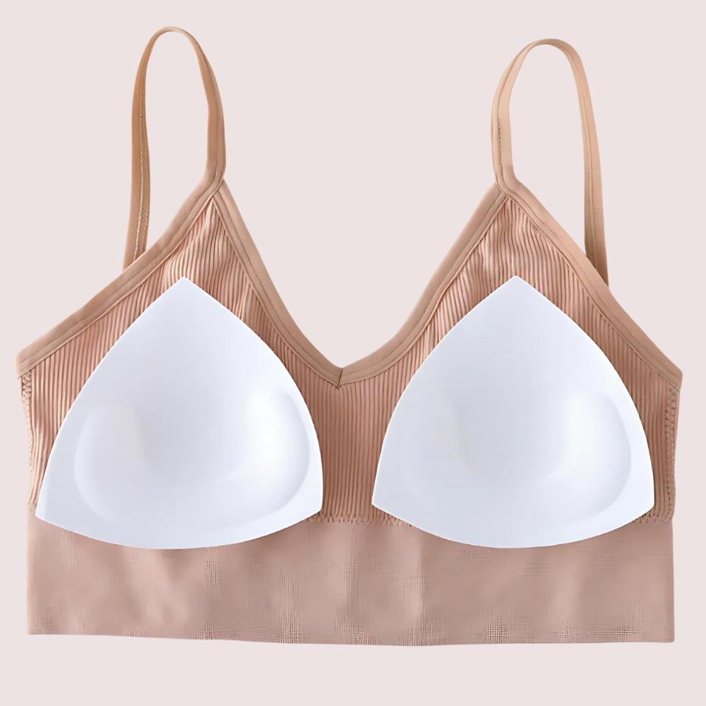 Brown bra with white cups on a beige background