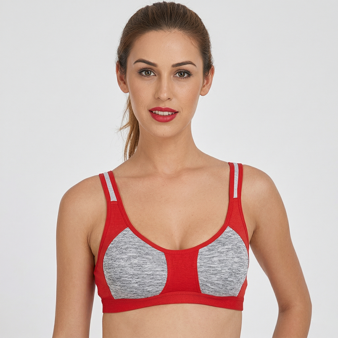 Woman wearing a red and gray sports bra on a white background