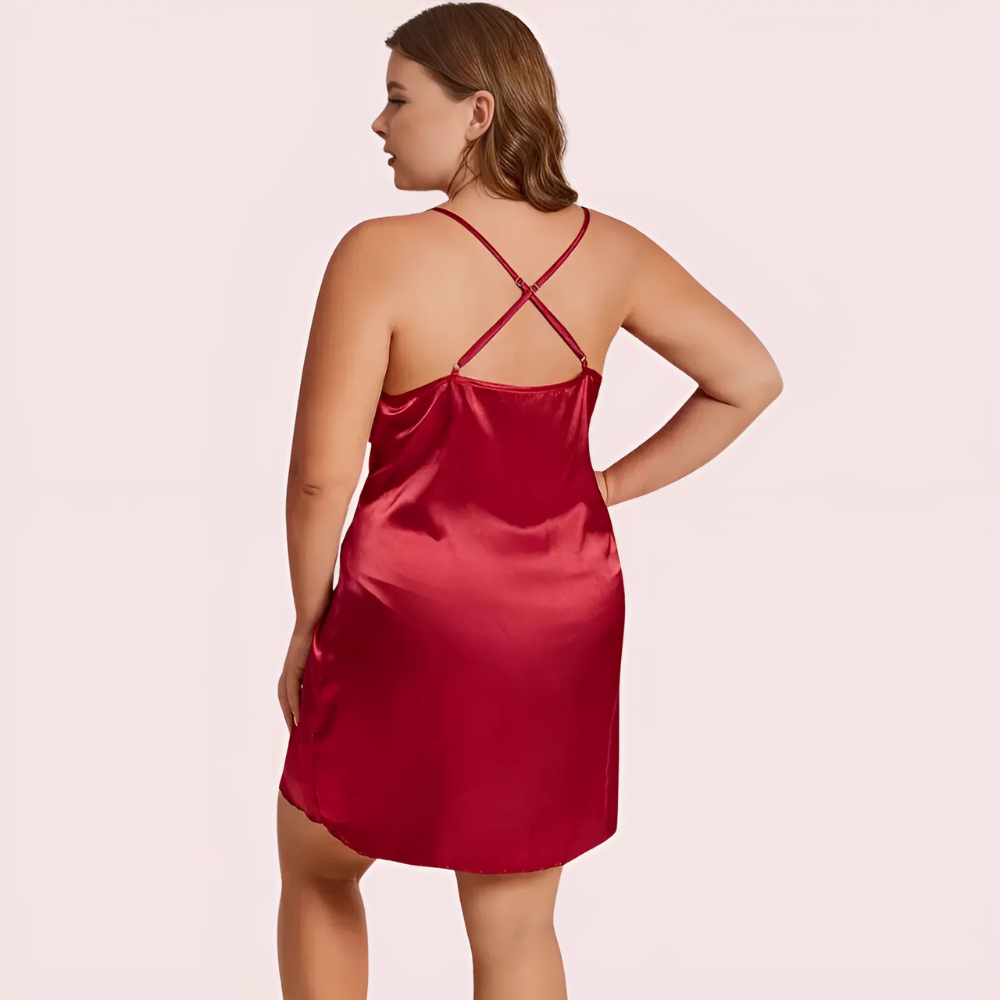 Red satin slip dress worn by a model on a light pink background