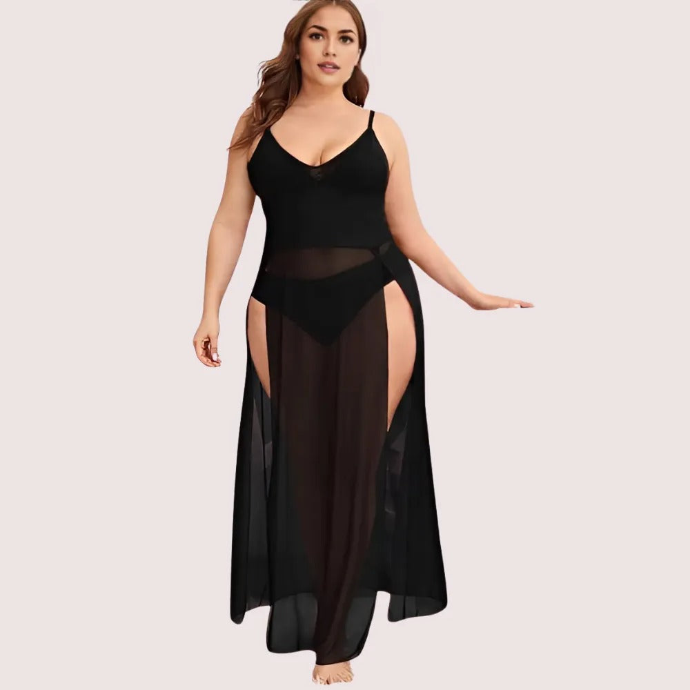 Woman wearing a black sheer dress on a light pink background